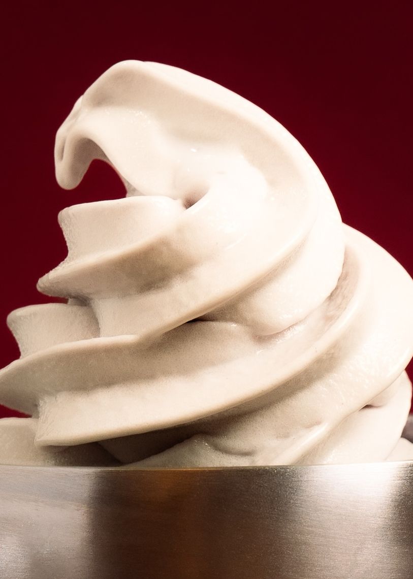 Product photography for SWORL featuring a protein soft serve swirl against a burgundy backdrop by TRUFFL branding agency